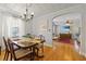 Elegant dining room with hardwood floors, chandelier, and a view into the living room at 1298 French Santee Rd, Jamestown, SC 29453