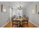 Formal dining room featuring hardwood floors, elegant chandelier and a wooden table set for six at 1298 French Santee Rd, Jamestown, SC 29453