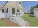 Charming white home with stairs leading to the front door and a green yard at 1298 French Santee Rd, Jamestown, SC 29453