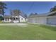 Exterior view of a white home with a large three-door garage and a covered porch, surrounded by a spacious yard at 1298 French Santee Rd, Jamestown, SC 29453