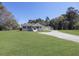 Sprawling ranch home with a large front yard and a long driveway to a detached garage at 1298 French Santee Rd, Jamestown, SC 29453