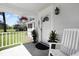 Inviting front porch with white rocking chair, potted plants, and a hanging flower basket near the front door at 1298 French Santee Rd, Jamestown, SC 29453