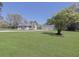 Charming home with large front yard, mature trees, and a detached three-car garage on a sunny day at 1298 French Santee Rd, Jamestown, SC 29453