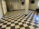 Garage space with stainless steel refrigerator and black and white checkered flooring, with plenty of space at 1298 French Santee Rd, Jamestown, SC 29453