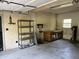 View of garage featuring shelving, workbench, and visible window providing natural light at 1298 French Santee Rd, Jamestown, SC 29453