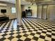 Well-lit garage with checkered floors, offering ample space and versatile storage options at 1298 French Santee Rd, Jamestown, SC 29453