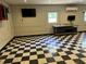 Spacious garage featuring black and white flooring, multiple windows, and mounted tvs at 1298 French Santee Rd, Jamestown, SC 29453