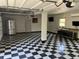 Spacious garage features black and white checkered flooring and ample space for parking and storage at 1298 French Santee Rd, Jamestown, SC 29453