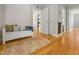 Spacious hallway featuring hardwood floors, a storage bench, and access to various rooms at 1298 French Santee Rd, Jamestown, SC 29453