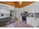 Modern kitchen with stainless steel appliances, white cabinets, and a mosaic tile backsplash at 1298 French Santee Rd, Jamestown, SC 29453