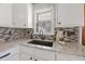 Bright kitchen features granite counters, modern backsplash, black faucet and sink, and ample cabinet storage at 1298 French Santee Rd, Jamestown, SC 29453