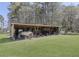 Outdoor storage shed featuring a boat, equipment and a corrugated metal roof at 1298 French Santee Rd, Jamestown, SC 29453