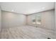 A bright bedroom is showcased with wood-look flooring and double windows with blinds at 1360 Burr Hill Rd, Cottageville, SC 29435