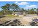 The exterior of the home features wood siding, a front door, and green trees at 1360 Burr Hill Rd, Cottageville, SC 29435