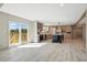 Open kitchen featuring a kitchen island, stainless steel appliances, and access to the outdoor deck through sliding doors at 1360 Burr Hill Rd, Cottageville, SC 29435