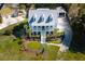 Beautiful aerial view of a blue two-story home featuring a charming front porch and dormer windows at 1367 N Edgewater Dr, Charleston, SC 29407
