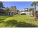 Expansive backyard featuring a well-maintained lawn, deck, storage shed, and charming pergola at 1367 N Edgewater Dr, Charleston, SC 29407