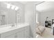 Bathroom featuring a single sink vanity, a mirror, and a doorway to a connecting bedroom at 1367 N Edgewater Dr, Charleston, SC 29407