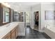 Luxurious bathroom with double sinks, tiled floors, a glass shower, and walk-in closet at 1367 N Edgewater Dr, Charleston, SC 29407