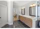 Bright bathroom featuring dual sinks, decorative mirrors, and a separate shower at 1367 N Edgewater Dr, Charleston, SC 29407