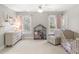 Cozy Bedroom with light-colored walls, two windows, neutral carpet, and a crib at 1367 N Edgewater Dr, Charleston, SC 29407