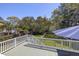 Relaxing deck with shade umbrella and picturesque views of the well-manicured backyard at 1367 N Edgewater Dr, Charleston, SC 29407