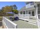 Charming outdoor deck with comfortable seating and a shade umbrella, perfect for relaxation at 1367 N Edgewater Dr, Charleston, SC 29407