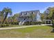 Attractive property with a charming front porch, complemented by well-kept landscaping and mature trees at 1367 N Edgewater Dr, Charleston, SC 29407