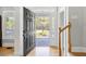 Entryway featuring a dark wood door, hardwood floors, and a glimpse of the outdoor landscape at 1367 N Edgewater Dr, Charleston, SC 29407