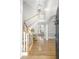 Inviting foyer with hardwood floors, a staircase, and an open view into the living area at 1367 N Edgewater Dr, Charleston, SC 29407