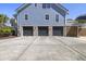 Exterior view of blue home with three car garage at 1367 N Edgewater Dr, Charleston, SC 29407