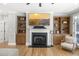 Warm and inviting living room with hardwood floors, fireplace, television and comfortable seating and built-in bookshelves at 1367 N Edgewater Dr, Charleston, SC 29407