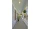 Covered porch featuring decorative columns, hanging plants, and a view of the lush surroundings at 1367 N Edgewater Dr, Charleston, SC 29407