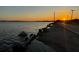 Scenic sunset view of lake featuring a tranquil shoreline and vibrant, colorful sky at 1367 N Edgewater Dr, Charleston, SC 29407