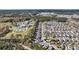 Aerial view of residential neighborhood, including a school, community pond, and houses with manicured lawns at 1391 Crane Creek Dr, Mount Pleasant, SC 29466