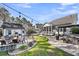 Spacious backyard featuring a patio with a fire pit, an outdoor dining area, and a well-manicured lawn at 1391 Crane Creek Dr, Mount Pleasant, SC 29466