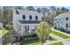 Inviting two-story white home with a cozy front porch and lush landscaping in a serene neighborhood setting at 1391 Crane Creek Dr, Mount Pleasant, SC 29466