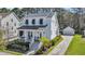 Charming two-story white home featuring a metal roof, inviting front porch, and a detached garage at 1391 Crane Creek Dr, Mount Pleasant, SC 29466