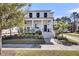 Charming two-story white home with a welcoming front porch and lush landscaping at 1391 Crane Creek Dr, Mount Pleasant, SC 29466