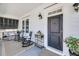 Inviting front porch featuring comfortable seating, a cozy fire pit and a stylish front door at 1391 Crane Creek Dr, Mount Pleasant, SC 29466