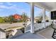 Inviting front porch with white columns, decorative planters, and cozy seating, offering a charming outdoor space at 1391 Crane Creek Dr, Mount Pleasant, SC 29466