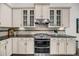 Close up of gourmet kitchen with stainless steel appliances, tile backsplash and custom cabinets at 1391 Crane Creek Dr, Mount Pleasant, SC 29466
