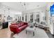 Bright living room featuring lots of windows, a stylish red leather sofa and fireplace at 1391 Crane Creek Dr, Mount Pleasant, SC 29466