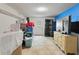 Tiled basement area with storage bins, dresser, and an exterior door for easy access at 1404 Ivy Isle Dr, Charleston, SC 29412