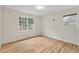 Cozy bedroom filled with natural light from two windows and featuring hardwood floors at 1404 Ivy Isle Dr, Charleston, SC 29412