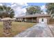 Charming brick home with a manicured lawn, columned driveway, and attached garage, showcasing its curb appeal at 1404 Ivy Isle Dr, Charleston, SC 29412