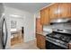 Well-lit kitchen boasting wood cabinets, stainless steel appliances, and a view of the adjacent dining area at 1404 Ivy Isle Dr, Charleston, SC 29412