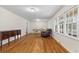 Spacious living area featuring hardwood floors, dining set, classic furniture, and large windows at 1404 Ivy Isle Dr, Charleston, SC 29412