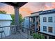 A cozy balcony view overlooking neighboring homes with vibrant sunset in the background at 15 Corinne St # B, Charleston, SC 29403