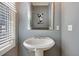 A clean bathroom features a white porcelain sink, lots of natural light, and neutral paint at 15 Corinne St # B, Charleston, SC 29403